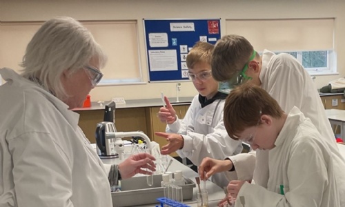 Mercury class working with the science teacher and using  test tubes